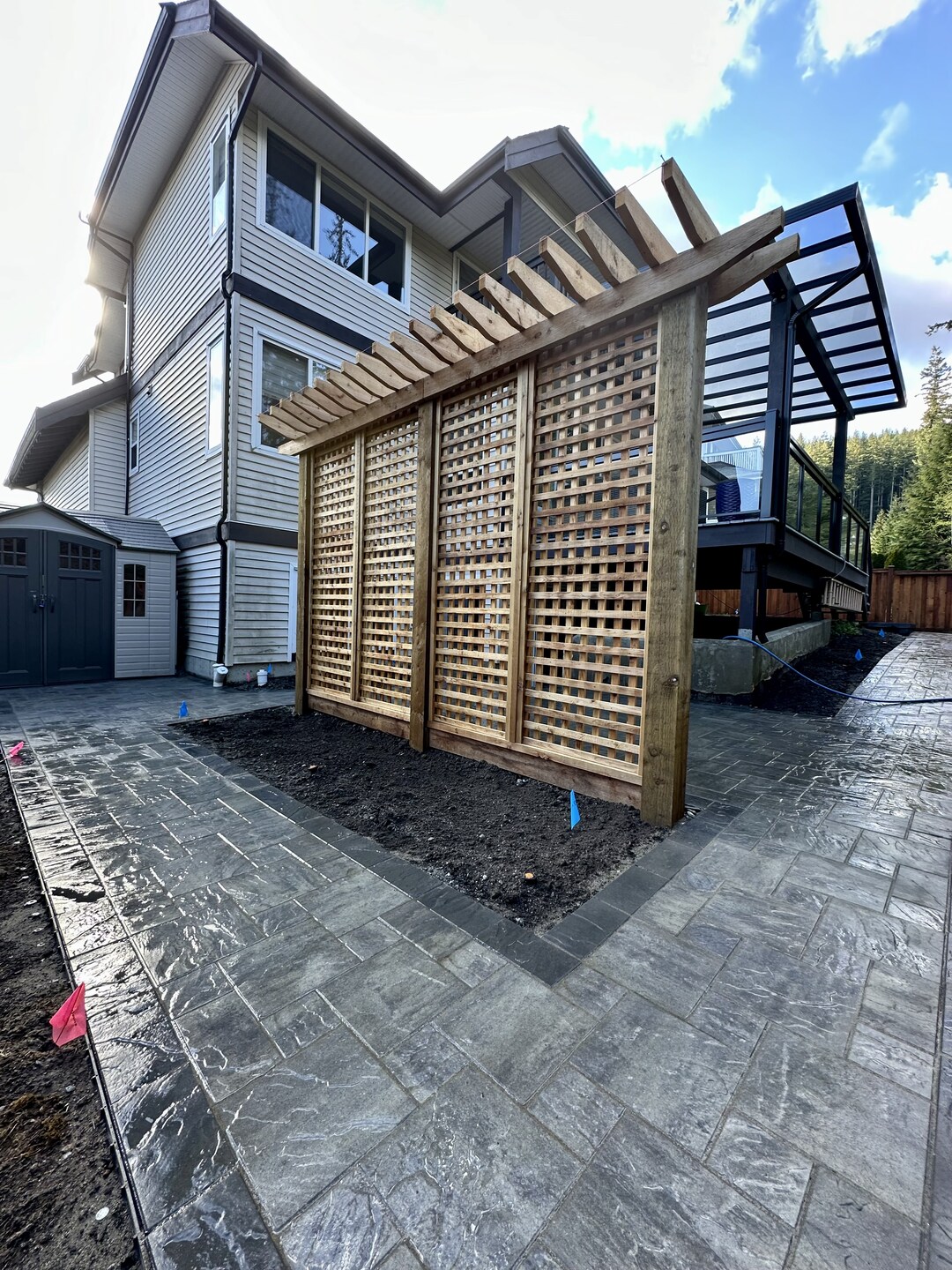 Concrete paver walkways and privacy trellis in North Vancouver built by Benjamin Landscaping and Projects. We pride ourselves in being the best paver contractor in the city. Port Moody, Coquitlam, White Rock, Surrey, Langley, West Vancouver, Port Moody.