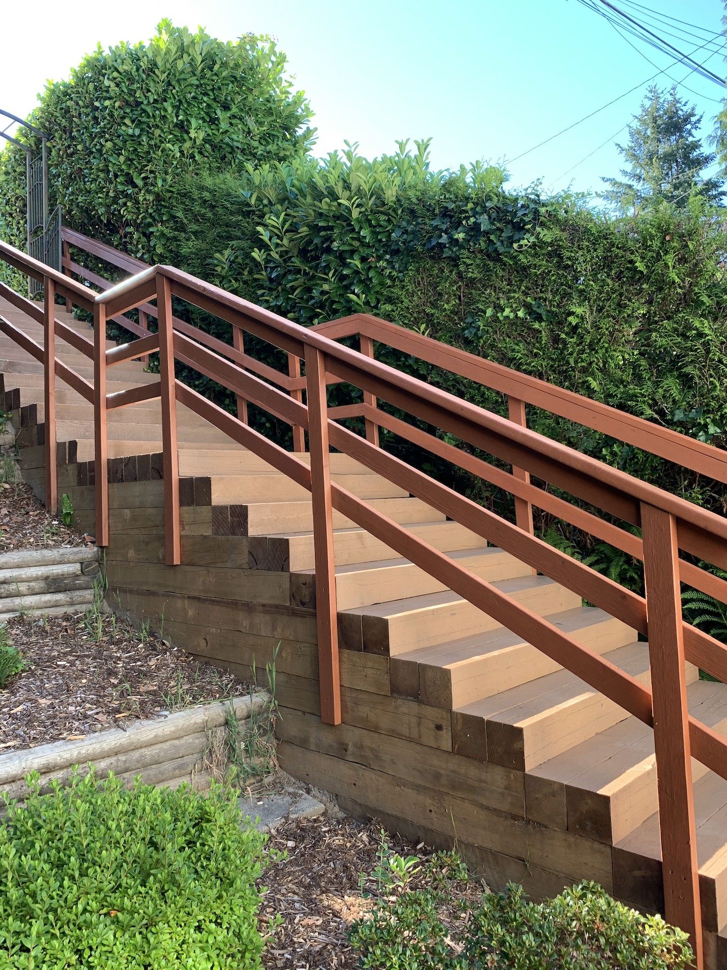 Pressure treated lumber stairs in Port Moody finished with stain. Benjamin Landscaping and Projects. 