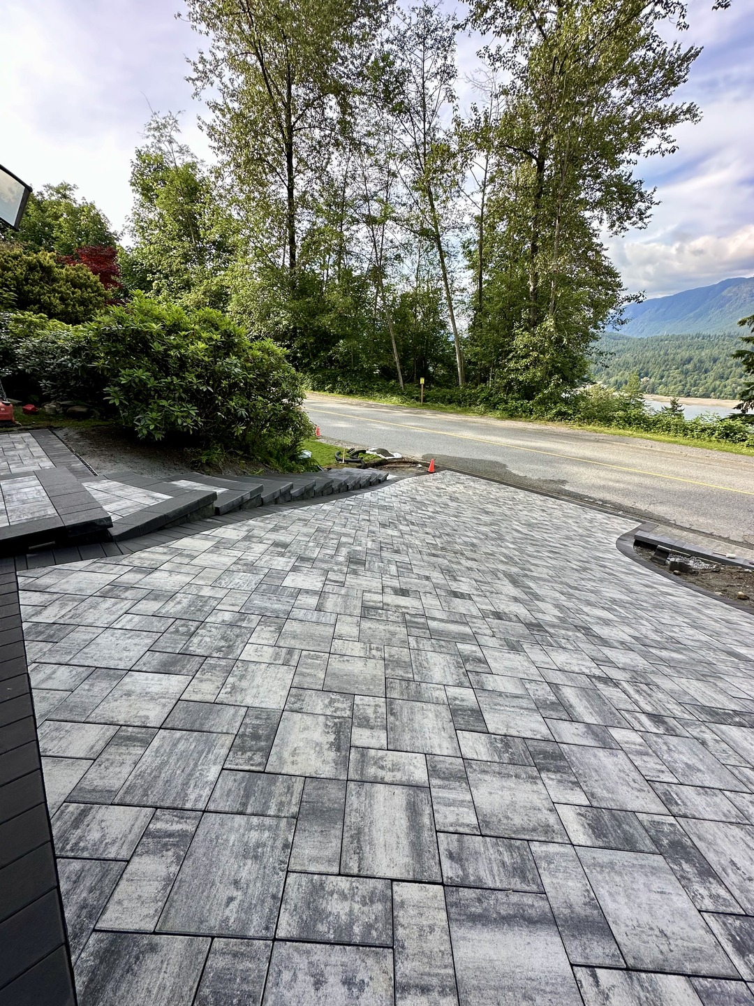 Interlocking concrete paver driveway and stairs In Port Moody by Benjamin Landscaping and Projects. 