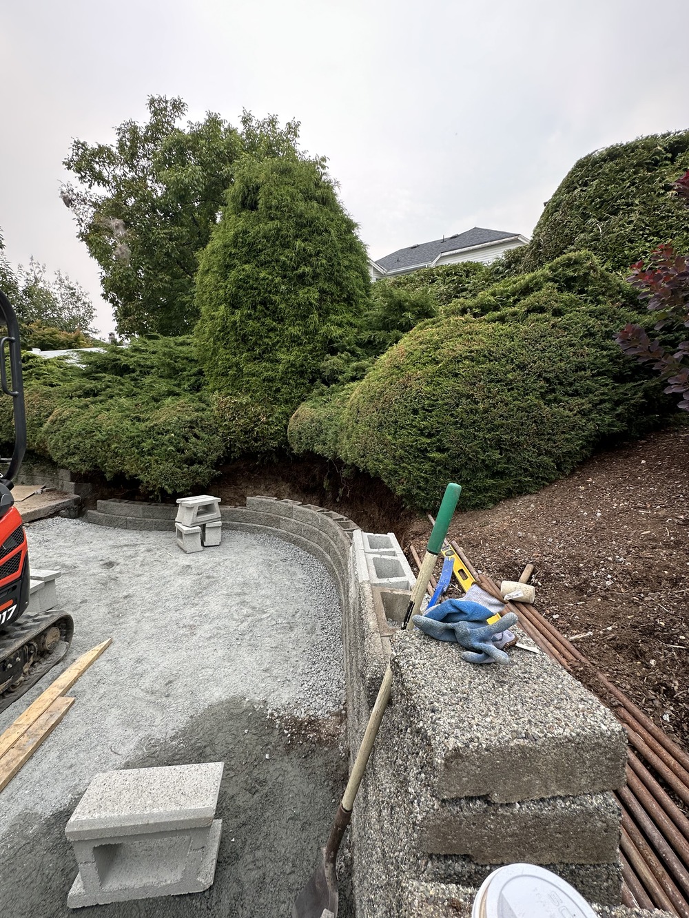 Retaining wall and Patio in Langley BC by Benjamin Landscaping and Projects. Interlocking paver patio and Allen Block wall.