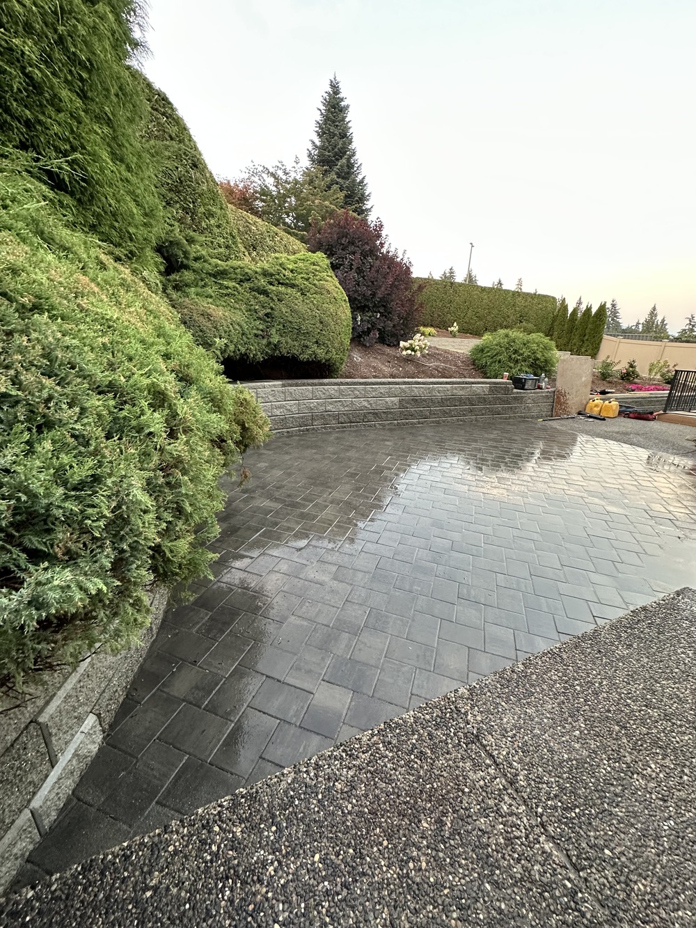 Retaining wall and Patio in Langley BC by Benjamin Landscaping and Projects. Interlocking paver patio and Allen Block wall.