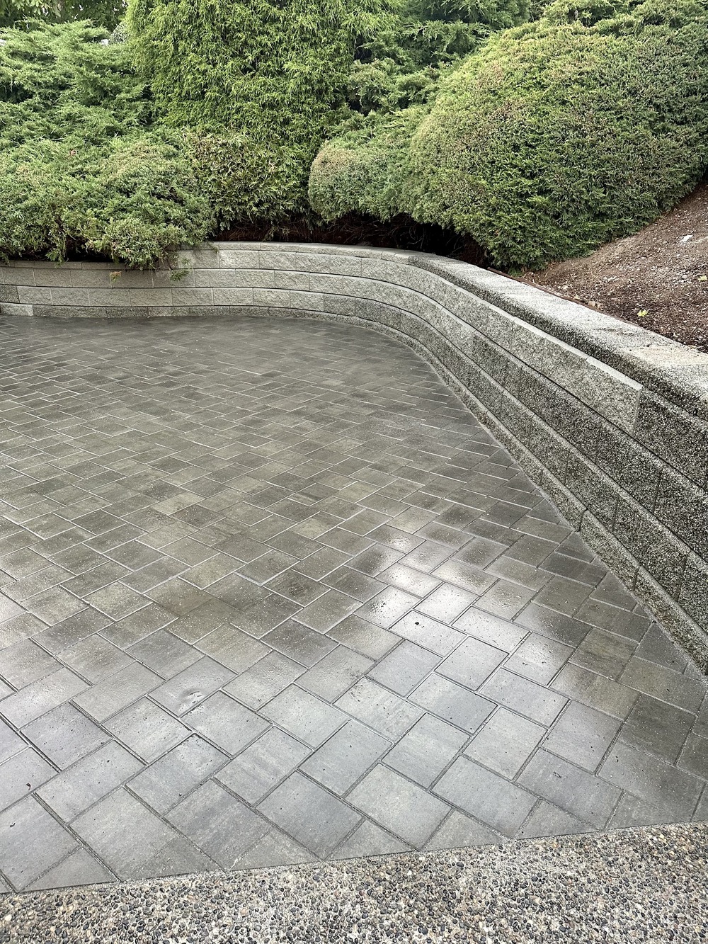 Retaining wall and Patio in Langley BC by Benjamin Landscaping and Projects. Interlocking paver patio and Allen Block wall.